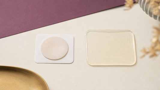 Unbranded round adhesive disc and translucent rectangular patch sample arranged side by side on a cream tabletop.
